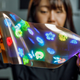 A person demonstrating the flexibility of LG's new 12-inch high-res OLED panel.